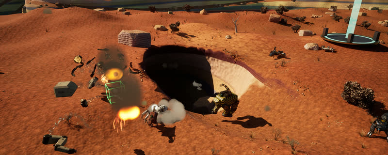 On the canyon rim by a tunnel's exit, mechs fight over a glowing pickup pad: explosions, flying debris and gun pickups.